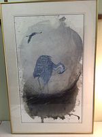Full view of framed artwork showing heron preening with gray watercolor background and small flying bird.