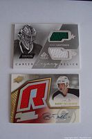 View of two numbered NHL trading cards; one with two jersey swatches and one autograph, confirmed mint condition as stated by seller.