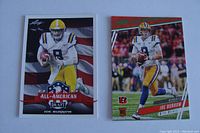 Two football rookie cards of Joe Burrow side-by-side. Left card is Leaf All-American Draft in LSU uniform with patriotic background. Right card is Panini Prizm showing Joe Burrow in mid-action in white LSU jersey.