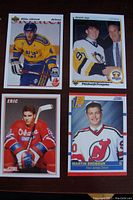 Four NHL rookie hockey cards: Lidstrom in yellow jersey, Jagr in Penguins uniform, Lindros in red Oshawa Generals uniform, Brodeur in Devils jersey.