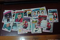 Full view photo of 14 NHL hockey cards from 1975-76 showing multiple teams and players