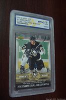 Front view of 2005-06 Upper Deck Sidney Crosby rookie card graded Gem Mint 10 by World Class Grading in a protective slab showing action image of Crosby and grading label.
