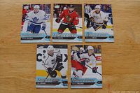 Front view of five Upper Deck Young Guns rookie hockey cards showing players Nikita Zaitsev, Tyler Motte, Pontus Aberg, Nic Dowd, and Sonny Milano in hockey uniforms.