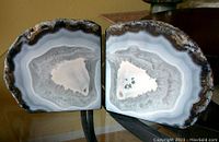 Top down front angle showing the interior polished surfaces of the two geode halves with crystalline banding.