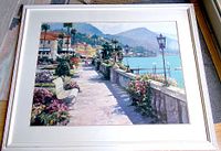 Full view of the framed print showing the coastal walkway scene and white frame.