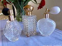 Three vintage cut/pressed glass perfume bottles with atomizers and spray pump in good condition
