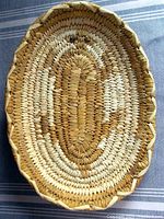 Top view of the oval basket tray showing the pictorial design and color pattern.