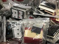 Overview photo showing many carded pairs of vintage stud earrings in plastic bags.