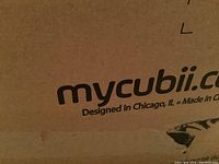 Partial view of MyCubii branded cardboard box indicating designed in Chicago, made in China.