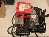 Power bars and boxed Electric Siren Model 49-529A on table