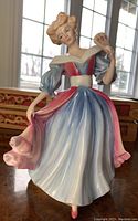 Front view of Royal Doulton Amy figurine showing detailed colored gown and facial features.