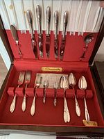 Boxed Community silverplate flatware set in red velvet-lined box with 18 pieces: 6 knives, 6 forks, 3 tablespoons, 1 sugar spoon, 1 butter knife, 1 serving spoon