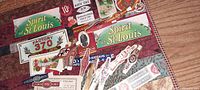 Photo showing various antique paper bands and labels including 'Spirit of St. Louis', 'Factory 370', and cigar-themed graphics.