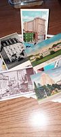 Collection of colorful vintage postcards showing buildings, city views, and landmarks.