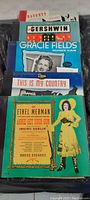 Photo showing multiple vintage record covers including Ragouts, Gershwin, Gracie Fields Souvenir Album, This Is My Country, and Annie Get Your Gun featuring Ethel Merman.