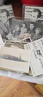 Postcards featuring black and white images of Richard Nixon, family scenes, and a military ship laid out together.