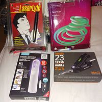 Photo of LaserLyte laser pointer, Lumineo Neonflex rope light box, CVS portable UV sterilizing wand, Helwin 23-tool multi-tool set box