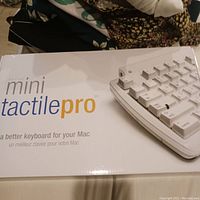 Original box of Mini Tactile Pro keyboard showing product branding and image of keyboard keys