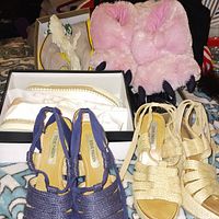 Photo showing both pairs of Steve Madden wedge sandals in navy blue and beige color with woven style, photographed on a blanket background with other shoes in background.