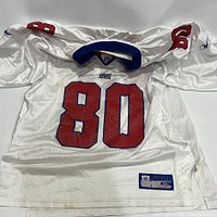 Front view of white Reebok NY Giants football jersey showing number 80 and some staining on bottom.