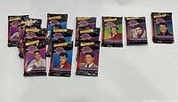 Thirteen sealed Elvis Presley trading card packs displaying six different images on the front of the packaging, arranged in a row.