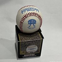 Photo of the Trump branded baseball on its original box showing the front logo and Professional Signature Series print.