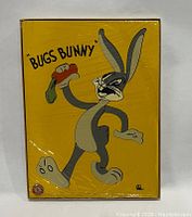 Front of the puzzle box showing colorful Bugs Bunny illustration with carrot, yellow background, and character name.