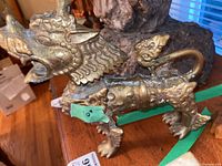 Side view of the Foo Dog highlighting the detailed face and mane, with open mouth and ornamental features.