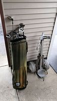 Golf bag and golf cart together, showing general lot contents.