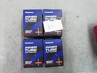 Four new Panaracer inner tubes for bicycles in blue boxes sized 26x2.20 to 2.50 inches.