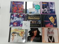 Photo of 9 various artists CDs arranged in three rows of three, with a handwritten $15 price card in the center.