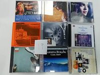 Photo showing all nine CD cases arranged in three rows, featuring various artists and genres including classical and soundtrack albums.