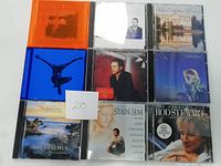 Nine CD cases arranged in three rows of three, showing front cover art visible for identification of albums.