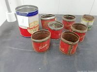 Front and top view of all 9 vintage tins including the Five Roses larger tin and 8 smaller tins.