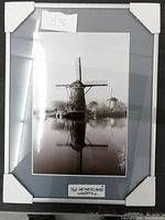Framed black and white photo of Dutch windmills reflecting in water, with mat labeled 'The Netherlands Windmill'.