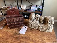 Photo showing both sets of bookends side by side on a wooden surface with background shelving.