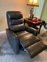 Recliner fully extended showing footrest and upholstery, positioned in living room.