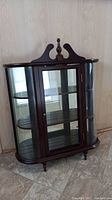 Full frontal view showing cabinet details and curved glass panels
