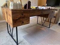 Front‐side view showing full desk, drawers closed, items on top