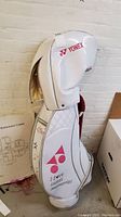 Full side view of white Yonex golf bag standing up, showing head cover and text 'I love sweet memories'.