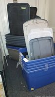 Photo shows a variety of stacked plastic storage bins and lids in blue, gray, and beige colors with varying sizes.