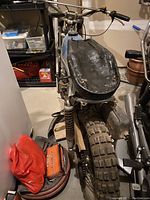 Front three-quarter view of blue Bultaco motorcycle showing fuel tank, frame, fork and knobby front tire