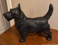 Side view of solid cast iron Scottie dog showing textured fur and upright tail.