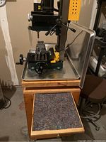 Craftex mini milling machine mounted on Veritas wooden drawer cabinet, one drawer open showing felt liner.