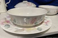 White porcelain bowl on matching floral dinner plate