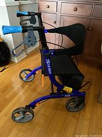 Full view of blue Excursion X20 four-wheel rollator walker showing frame, seat and handlebars