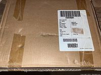 Photo showing closed cardboard box with shipping label.