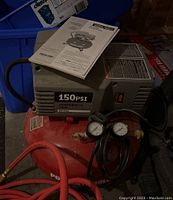 Overall compressor with instruction manual on top