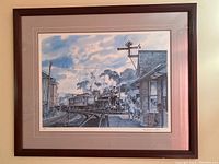 Full frontal view of one framed railway print showing steam locomotive at station platform