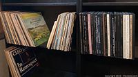 Wide view of vinyl record collection on black shelving including Cleo Laine In Retrospect and other classic LPs